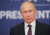 Vladimir Putin at a podium with microphone