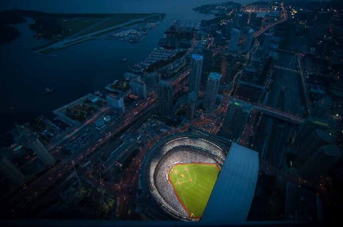 Baseball stadium illuminated at night in a coastal city