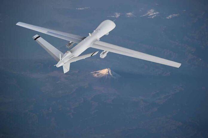Unmanned aerial drone flying over mountainous terrain