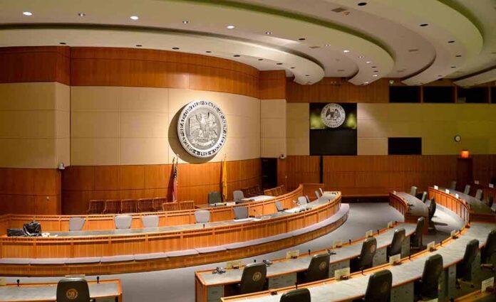 Interior view of a government chamber with wooden paneling and seating