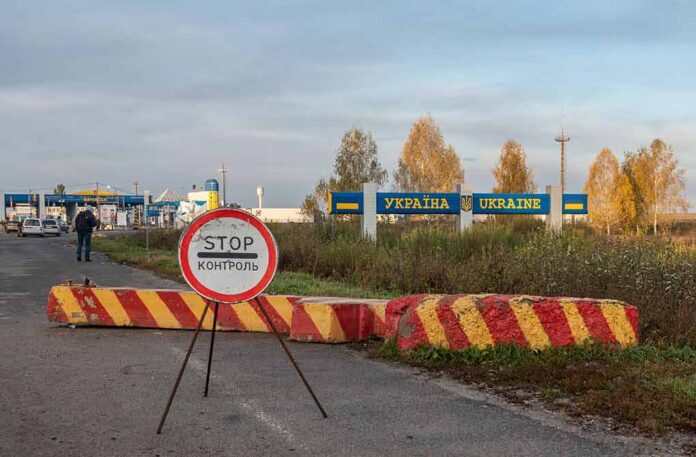 Ukraine border crossing with stop sign and barrier