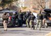 Aftergame Chaos: Teen Gunned Down Police and sheriff officers gather around vehicles on a suburban street