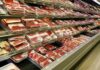 supermarket meat section with packaged cuts in refrigerated shelves