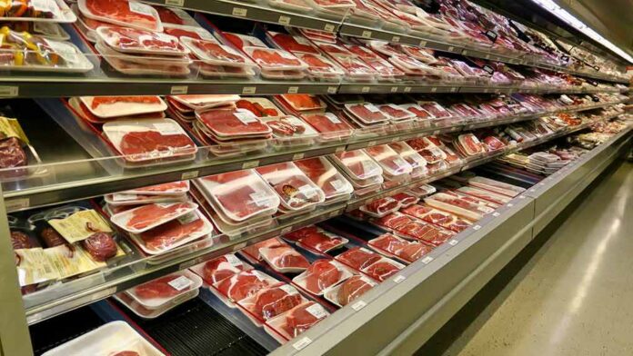 shutterstock_2171480915 supermarket meat section with packaged cuts in refrigerated shelves