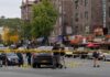 Police investigate a taped-off urban street crime scene