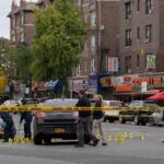 Police investigate a taped-off urban street crime scene
