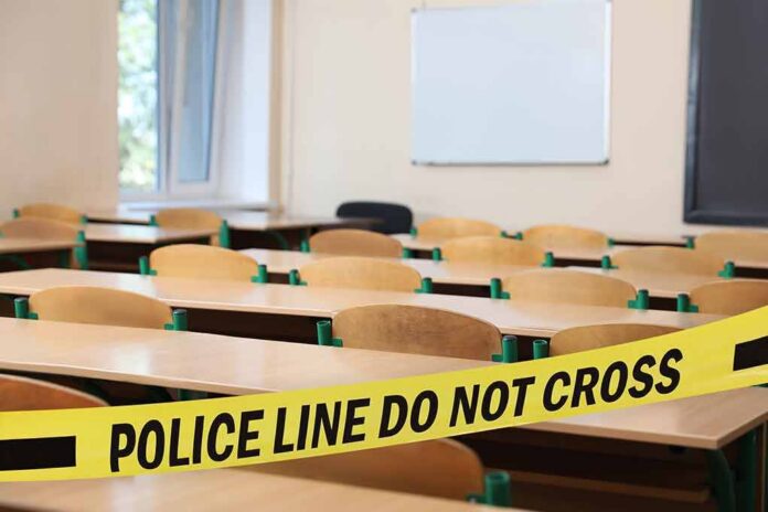Empty classroom with police tape across desks