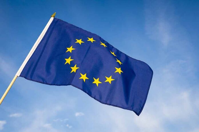 European Union flag waving against blue sky